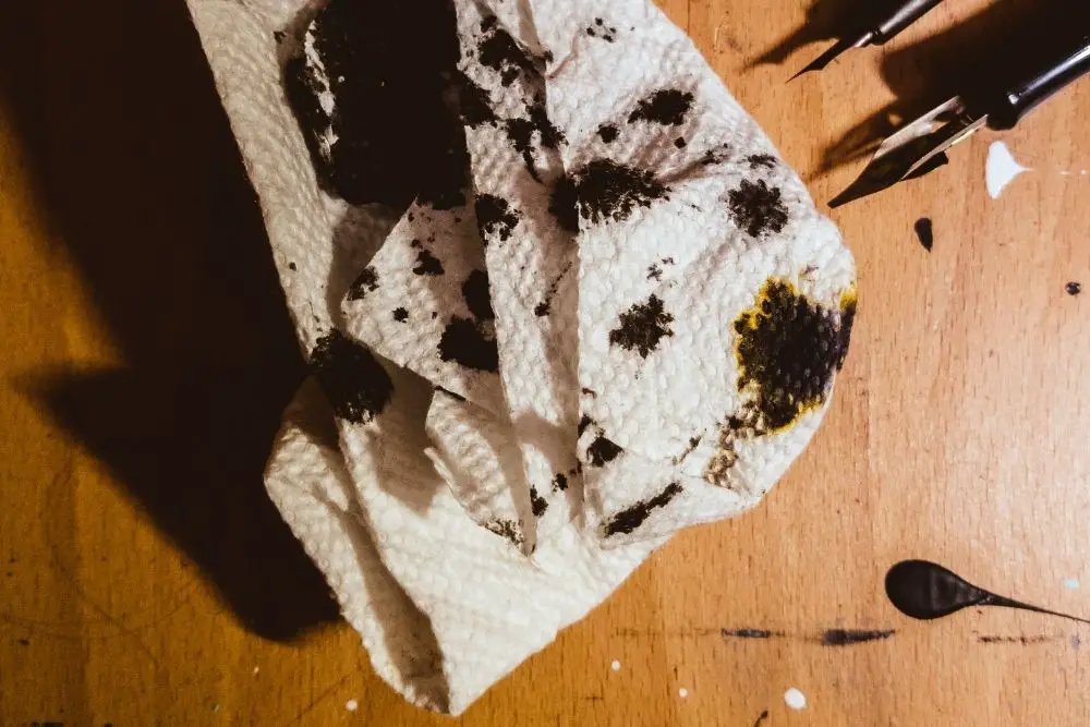 ink stain on wooden floor and tissue paper